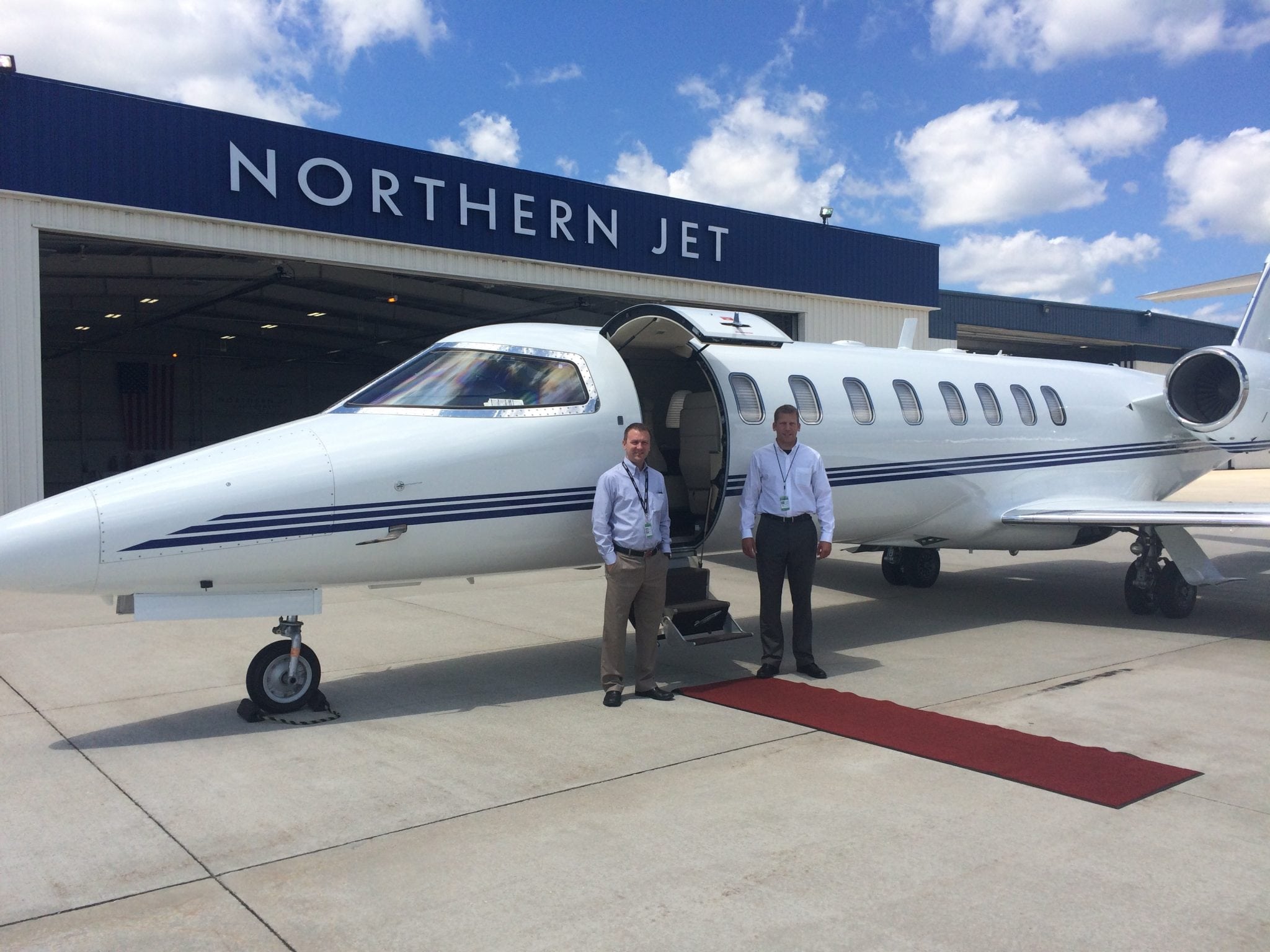 Pilots Steve Edmondson, left, and Andy Heemstra pose in front of the Bombardier Learjet 45XR they flew to establish the world record for a flight between Grand Rapids and Naples, Florida.