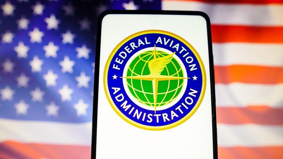 The FAA logo on a phone in front of an American flag